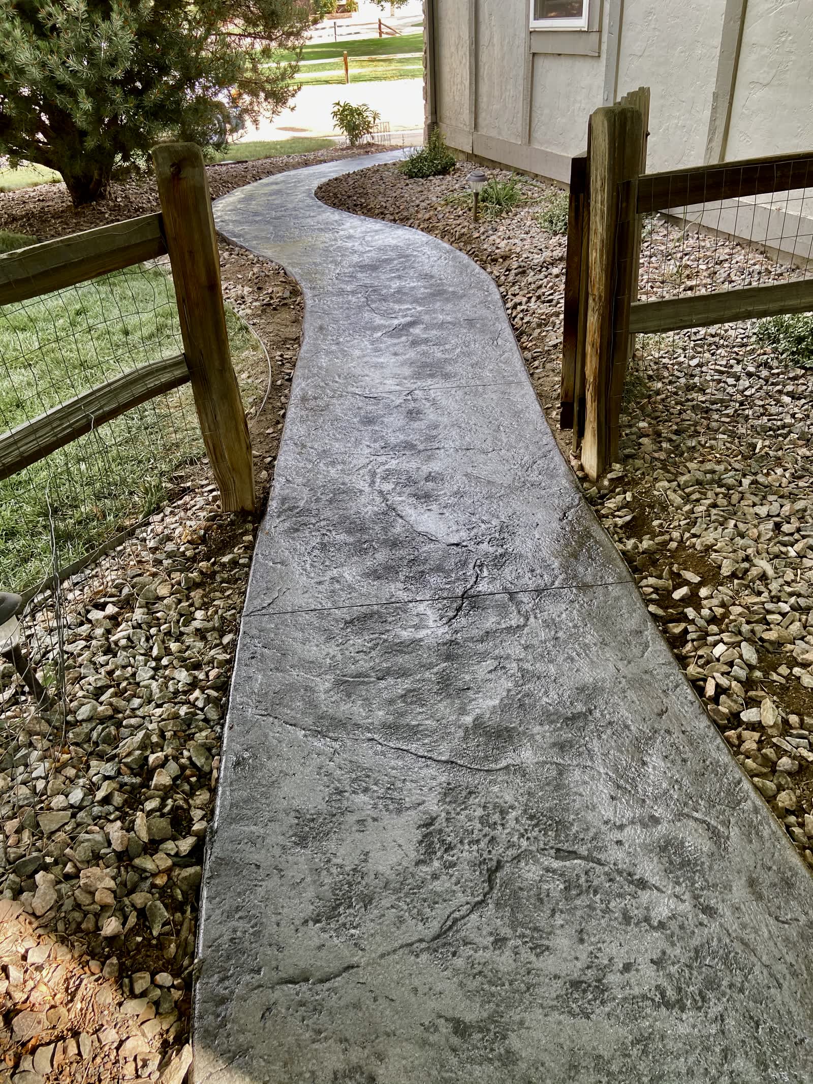 Curved stamped walkway at a lake house